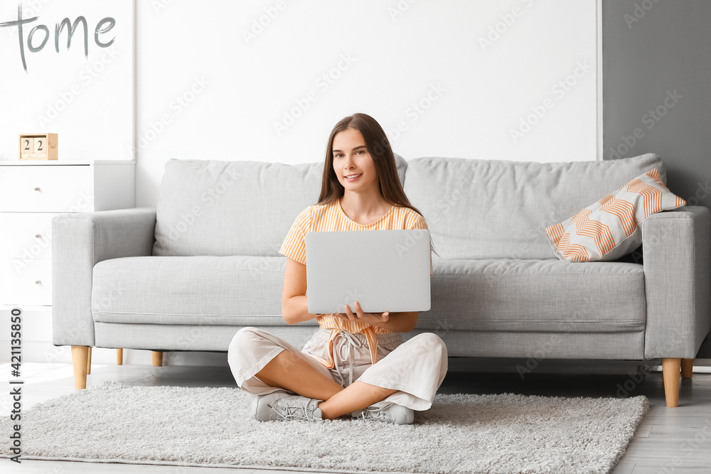 Young woman with laptop at home Young woman with laptop at home