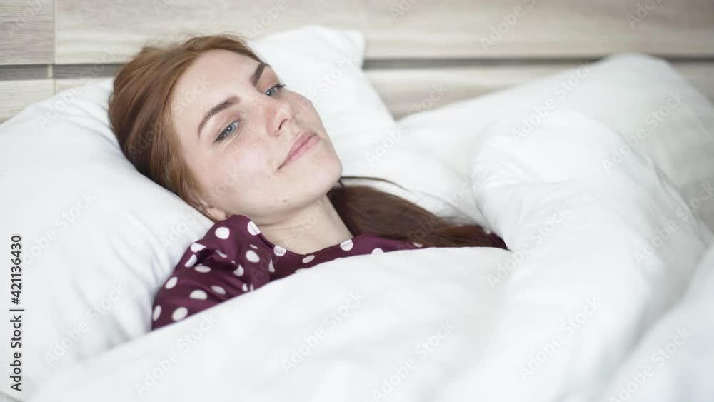 beautiful girl is sad in bed at home herself on self-isolation during quarantine beautiful girl is sad in bed at home herself on self-isolation during quarantine