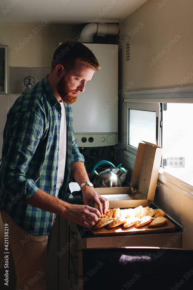 young man prepares lunch at home young man prepares lunch at home