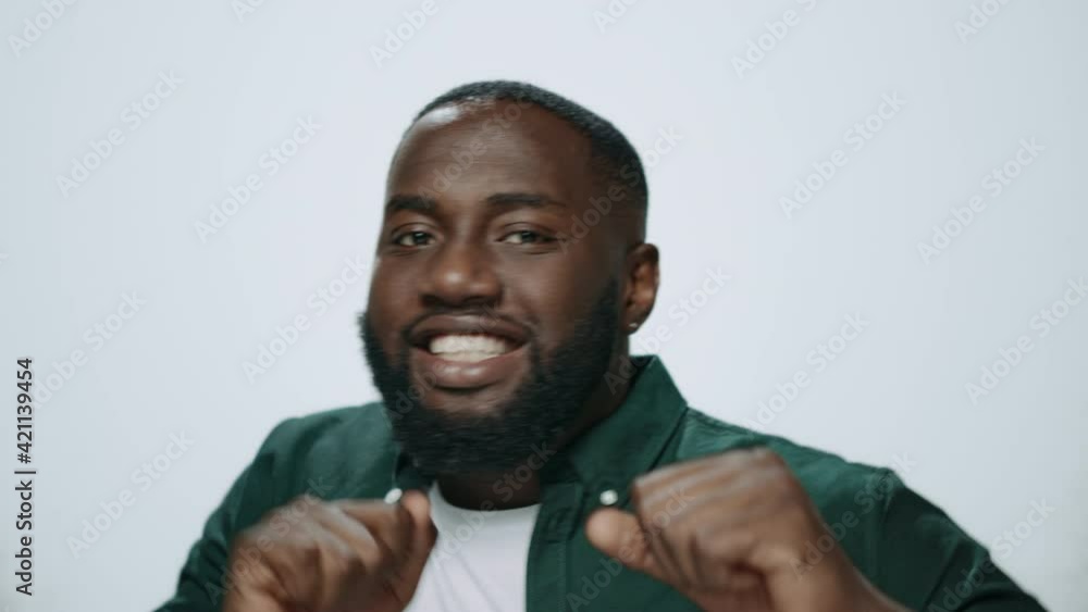 Portrait of smiling african american handsome man dancing in grey background. Portrait of smiling african american handsome man dancing in grey background.
