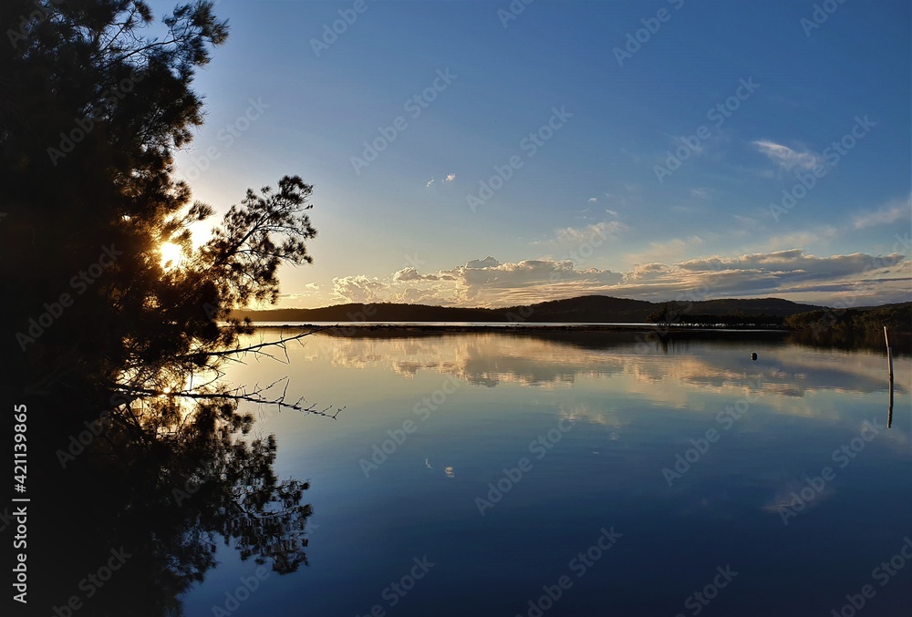 Mirror reflection on Queens Lake in Laurieton, New South Wales, Australia