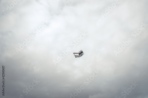 Wallet flying with a dark cloudy sky