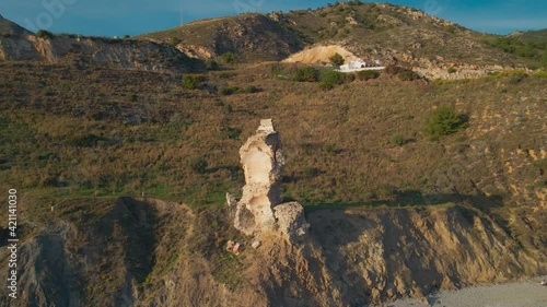 Drone flying around a peculiar ruin near the beach photo