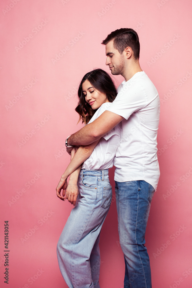 young cheerful caucasian couple together having fun on pink background, guy ang girl modern relationship, lifestyle people concept young cheerful caucasian couple together having fun on pink background, guy ang girl modern relationship, lifestyle people concept
