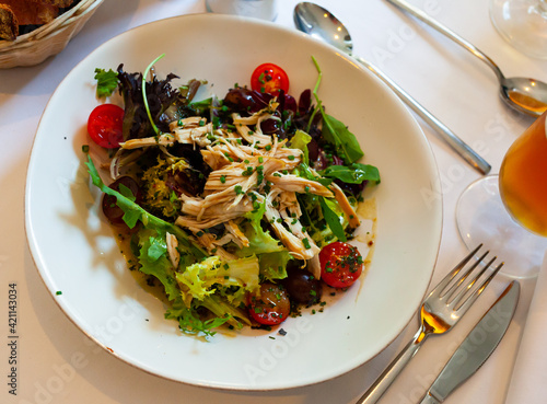 Tasty salad with chicken, arugula and cherry tomatoes at plate