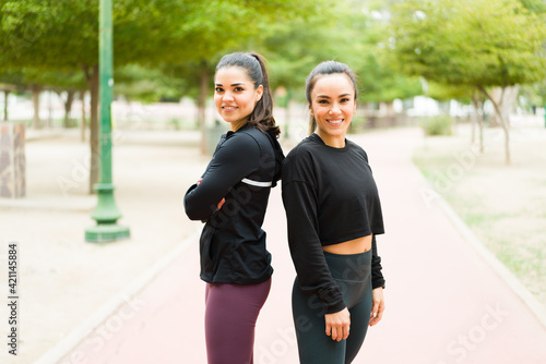 Happy workout partners in activewear exercising outdoors
