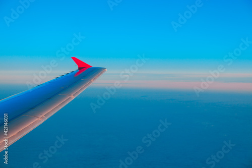 Airplane wing outside, view from interior of aircraft