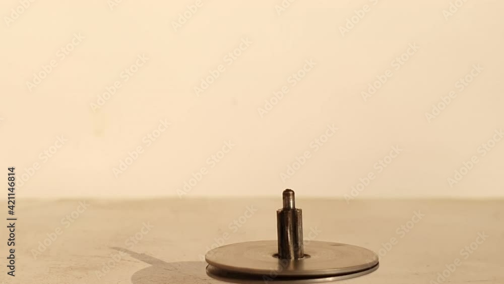 Toy iron spinning a rounding string also called lattoo in india. Its a kids game rounding fast. Toy iron spinning a rounding string also called lattoo in india. Its a kids game rounding fast.