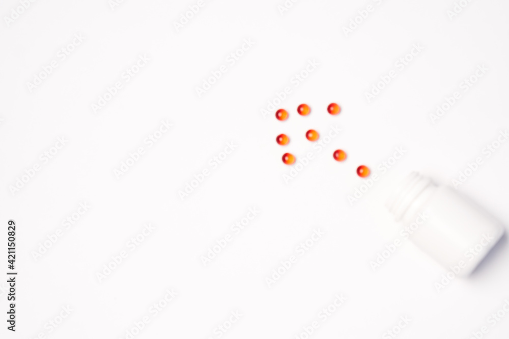 White jar with pills on a light background top view medicine health vitamins White jar with pills on a light background top view medicine health vitamins