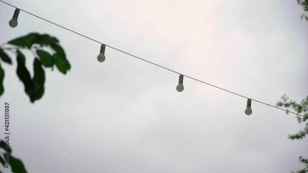 Garlands of incandescent lamps outdoors. Holiday string lights. High quality FullHD footage Garlands of incandescent lamps outdoors. Holiday string lights. High quality FullHD footage