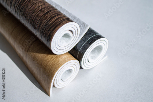 Photos Linoleum. Three rolls of linoleum on a white background.