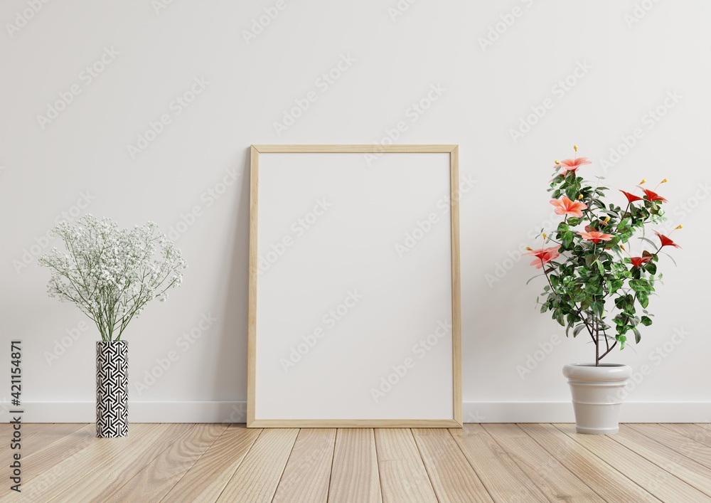 Mock up photo frame in the room, white wall on the wooden floor, beautiful pattern, decorated with plants on the side.3d rendering. Mock up photo frame in the room, white wall on the wooden floor, beautiful pattern, decorated with plants on the side.3d rendering.
