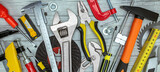 various renovation instruments and tools on grey background. screwdrivers, clamps, wrenches, keys top view