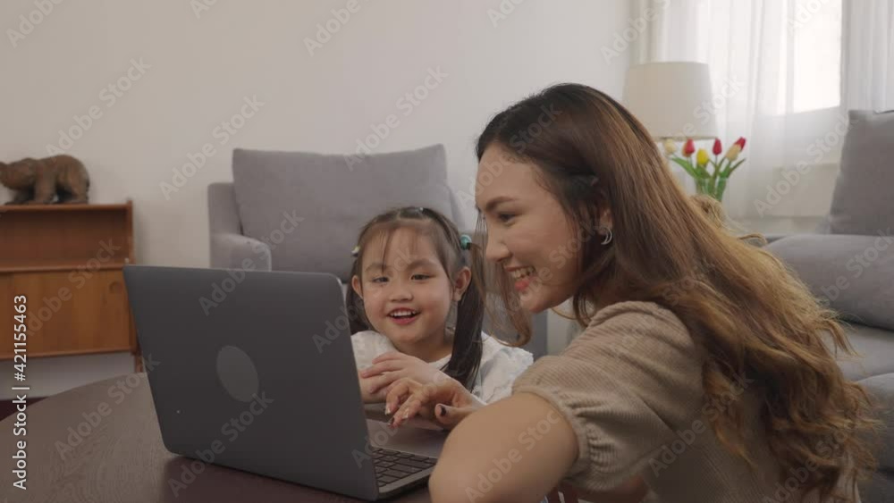 Mother and Daughter Watching into Laptop at Home. Daughter Helping Mother. Mother and Daughter at Home. Teenage Girl. Freelancing Mother Concept. Women Using Digital Device. Smiling Woman. Mother and Daughter Watching into Laptop at Home. Daughter Helping Mother. Mother and Daughter at Home. Teenage Girl. Freelancing Mother Concept. Women Using Digital Device. Smiling Woman.
