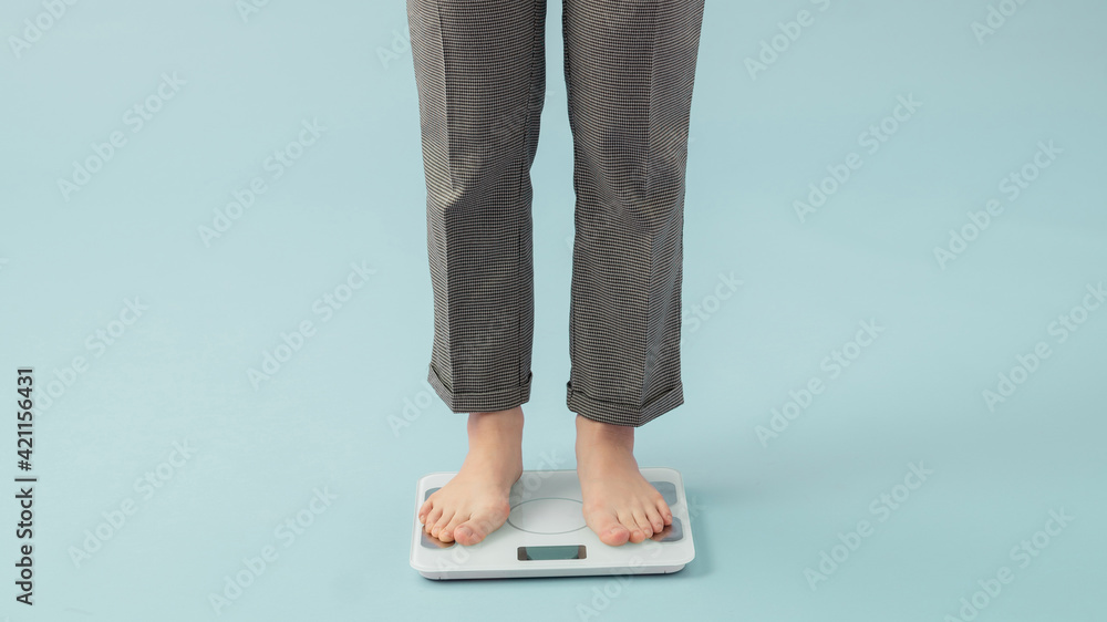 Asian beautiful woman standing on the Weight Scale at home gym ...