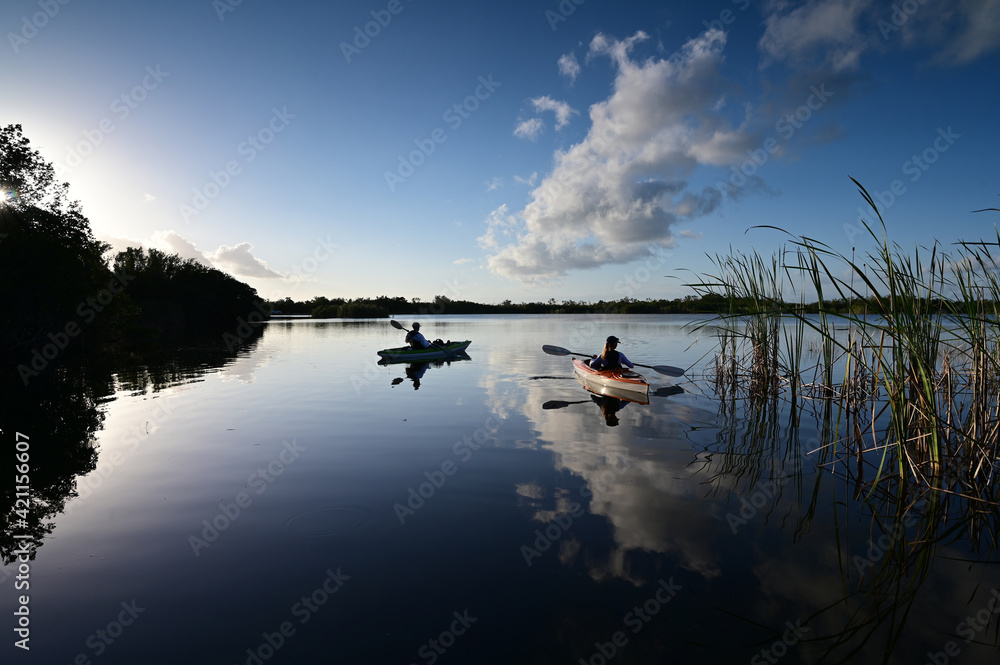 Woman and active senior kayaking on Nine Mile Pond in Everglades National Park.