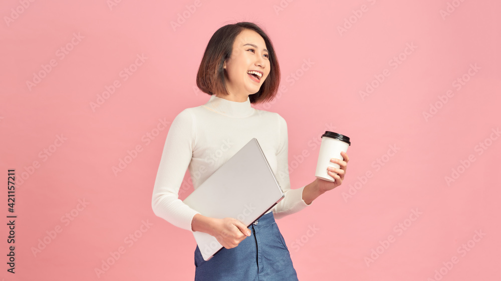 Young beautiful woman drinking coffee holding clipboard isolated over pink background Young beautiful woman drinking coffee holding clipboard isolated over pink background