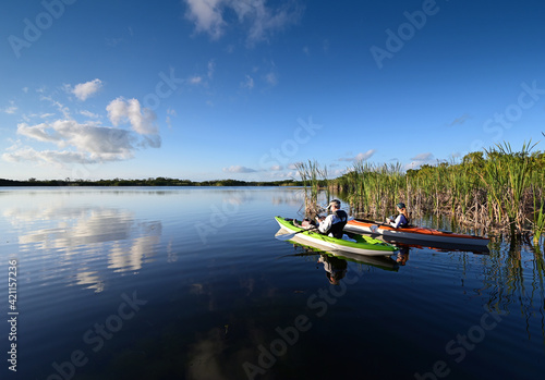 Woman and active senior kayaking on Nine Mile Pond in Everglades National Park.
