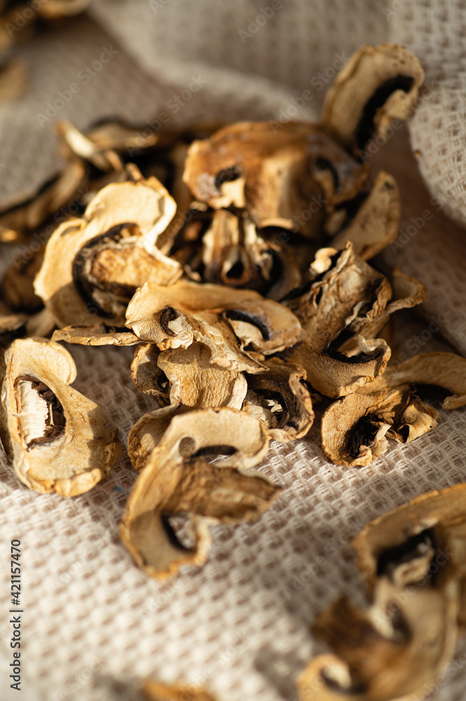 dried chopped mushrooms champignons, scattered on the table in bright daylight, blank, semi-finished product, additive for cooking dried chopped mushrooms champignons, scattered on the table in bright daylight, blank, semi-finished product, additive for cooking