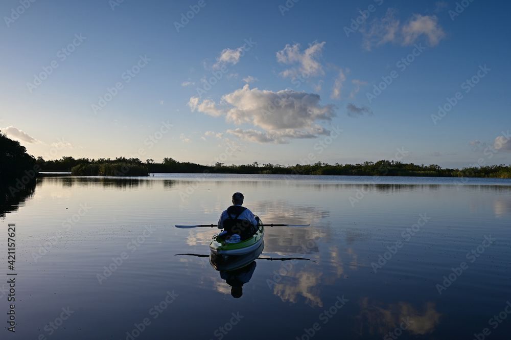 Active senior kayaking on Nine Mike Pond in Everglades National Park, Florida.