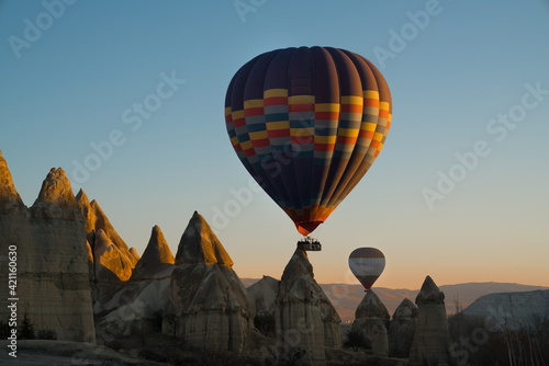 Hot air balloon flying over spectacular Cappadocia, Goreme at sunrise.