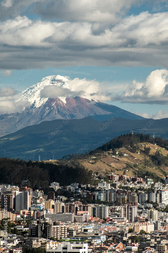 A view of Quito with Cotopaxi volcano in the background