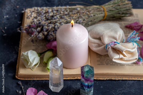 Fotografie Magic still life with fluorite, quartz crystal and pink candle