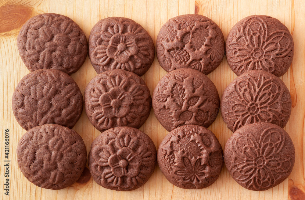 Round chocolate cookies with patterns on wooden table Round chocolate cookies with patterns on wooden table