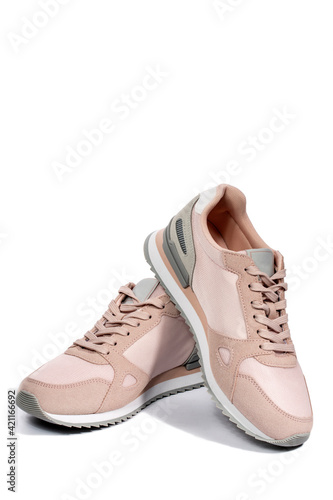 Light pink summer sneakers on a white background