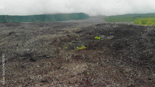 Epic and aerial shot by drone of lava flow, cloudy. Reunion island, idian ocean.  photo