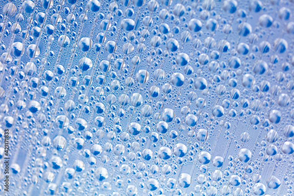 Water drops on blue glass as an abstract background. Water drops on blue glass as an abstract background.