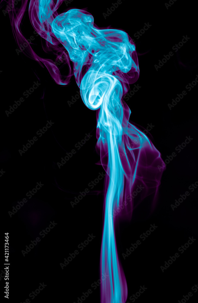 Fototapeta premium Purple and blue smoke isolated on black background. Abstraction