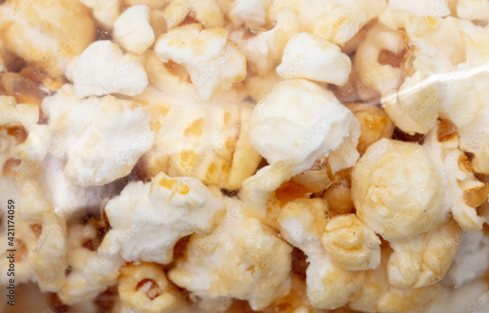 Popcorn in a plastic bag as a background. Popcorn in a plastic bag as a background.