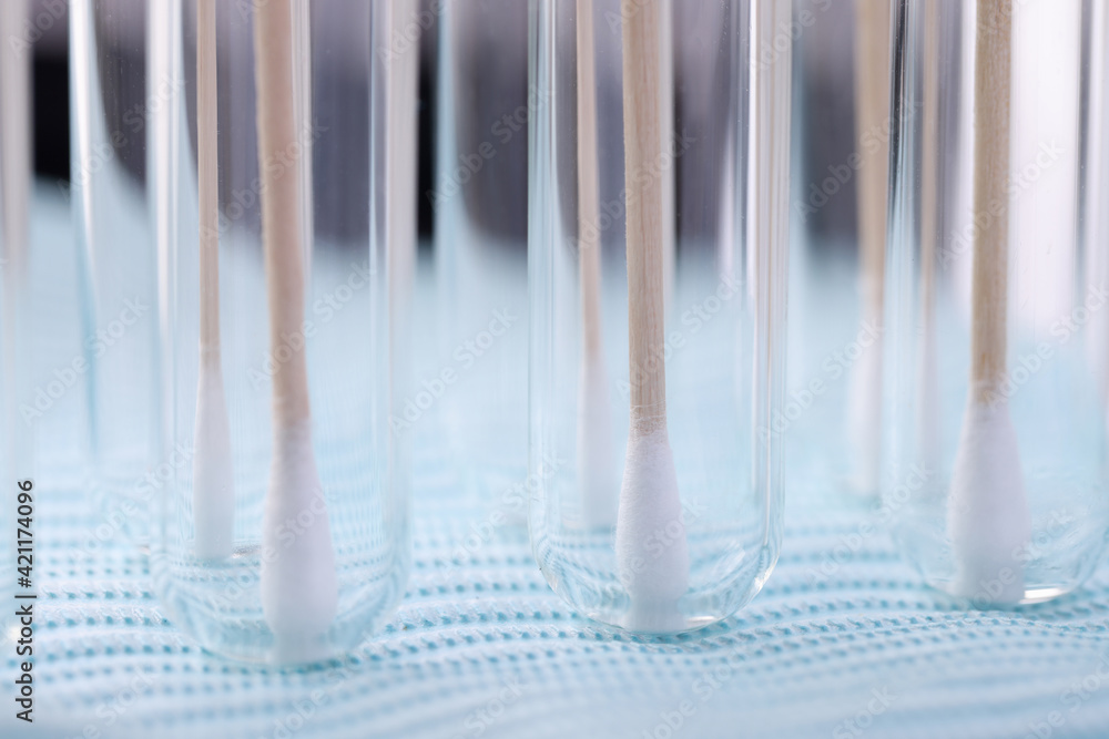 In test tube there are medical sticks for taking biological materia In test tube there are medical sticks for taking biological materia
