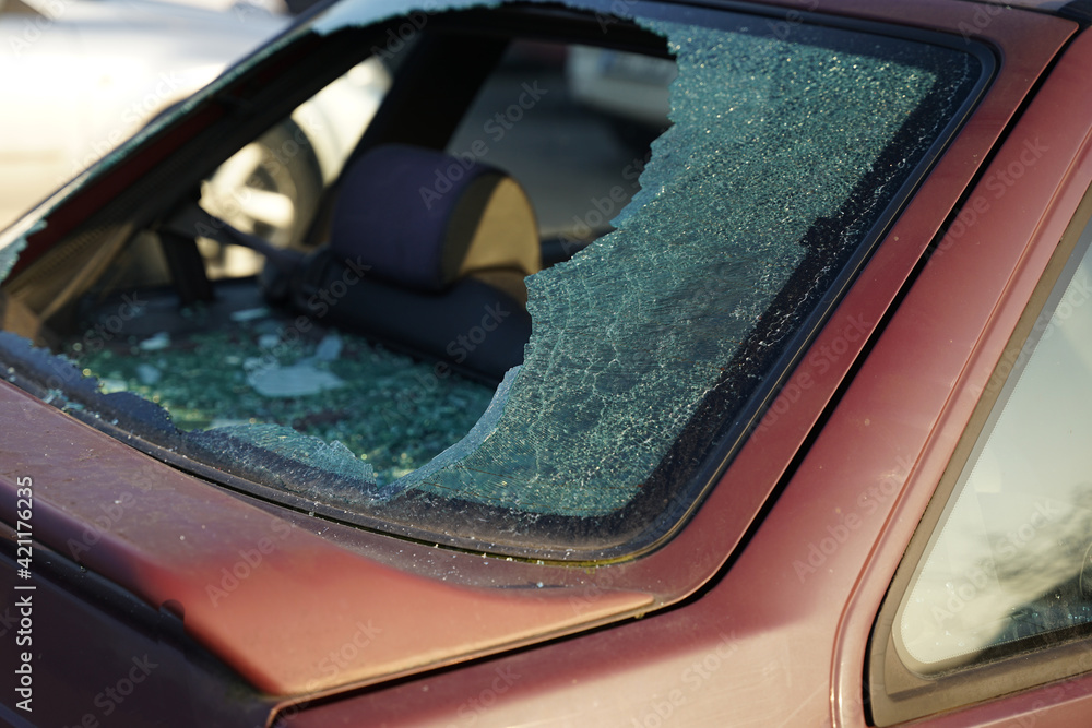 Somebody vandalized rear window in car, thief smashed window and stole valuable items concept