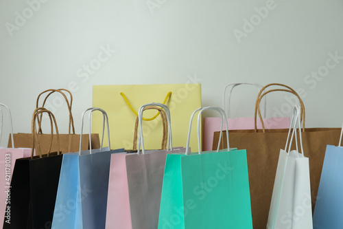 Different colorful paper bags on white background