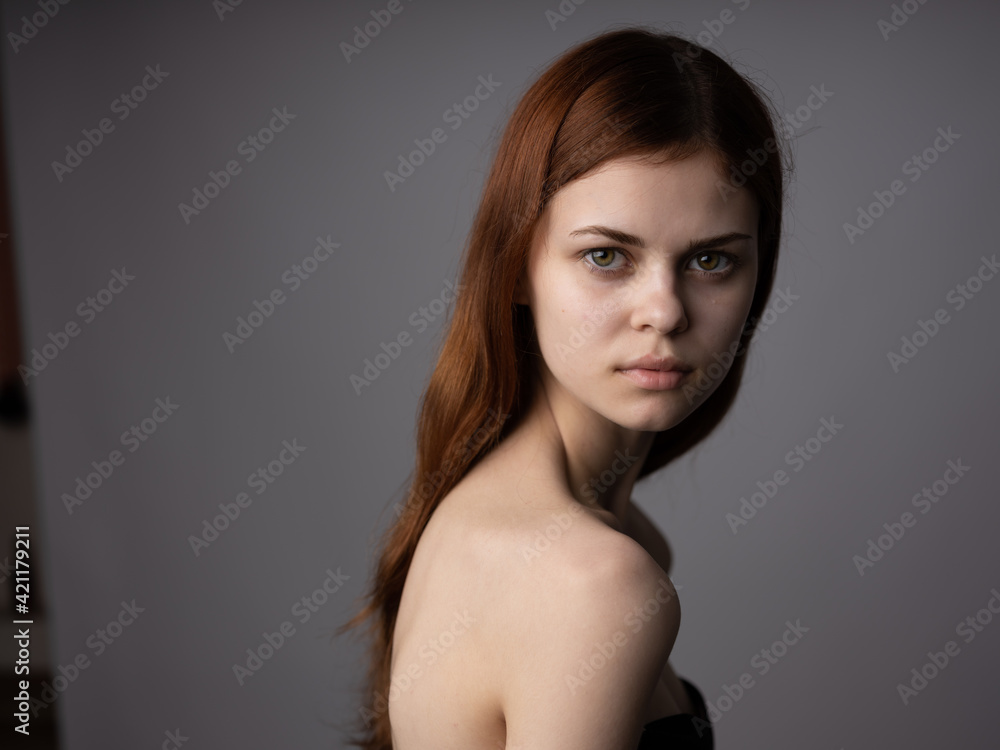 Woman portrait on gray background charming model red hair cropped look Woman portrait on gray background charming model red hair cropped look