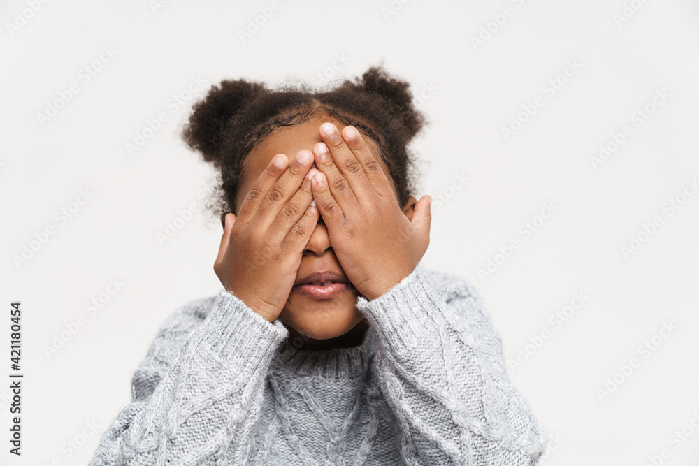 African curly girl wearing sweater covering her eyes African curly girl wearing sweater covering her eyes