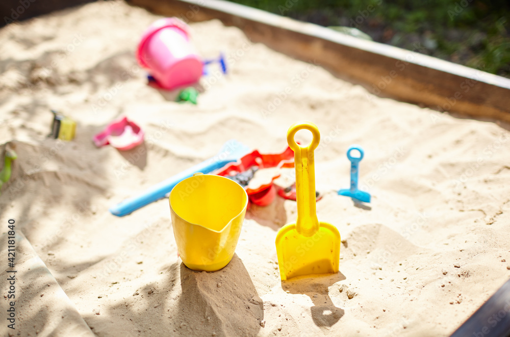 Sandbox outdoor. Children's wooden sandbox with various toys for the game - obrazy, fototapety, plakaty 