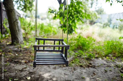Wooden swing at garden. Selective focus with shallow depth of field
