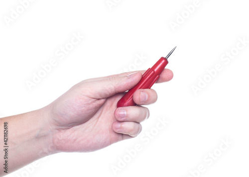 Man holds an awl in his hand on a white background  isolate. Close-up  production