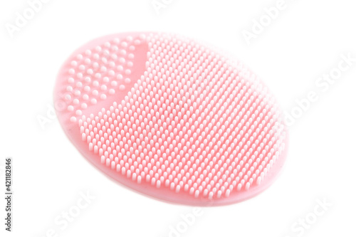 Pink silicone cosmetic facial brush on a white background, isolate. Skin care, macro