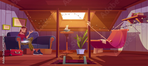 Woman seats with tablet on couch on attic