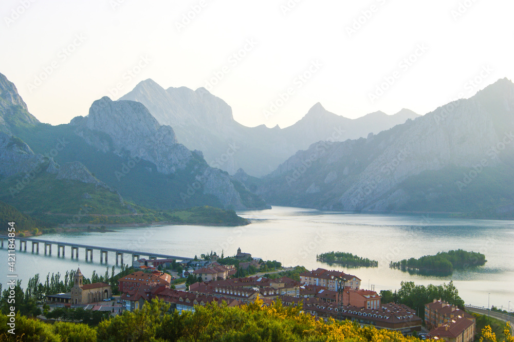 Fototapeta premium Bridge crossing a lake between mountainous villages at sunset in Spain.