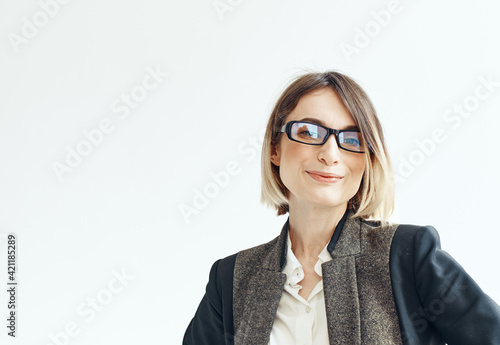 A woman in a suit with a pencil in her hands on a light background business financial director of the firm