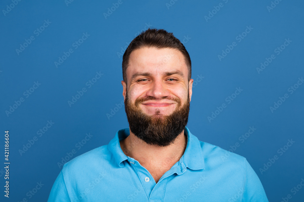 Caucasian man's portrait isolated on blue studio background with copyspace Caucasian man's portrait isolated on blue studio background with copyspace
