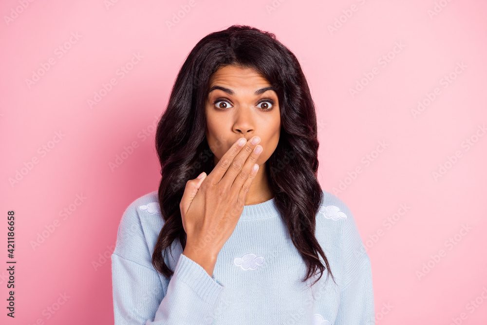 Photo of speechless girl palm cover mouth look camera wear blue cloud print sweater isolated pink background