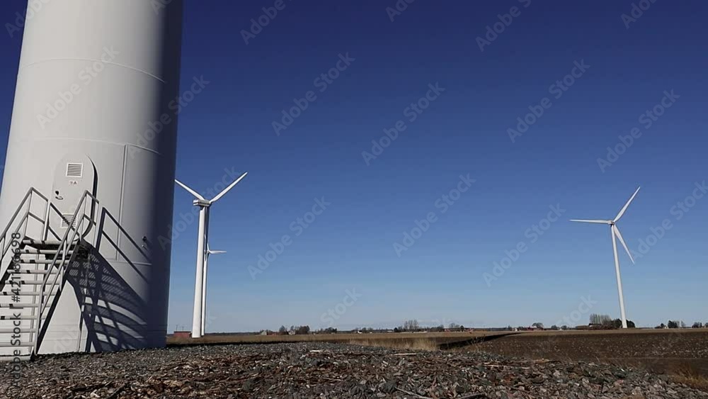 Lidkoping, Sweden Wind turbines on an open field and a blue sky. Lidkoping, Sweden Wind turbines on an open field and a blue sky.