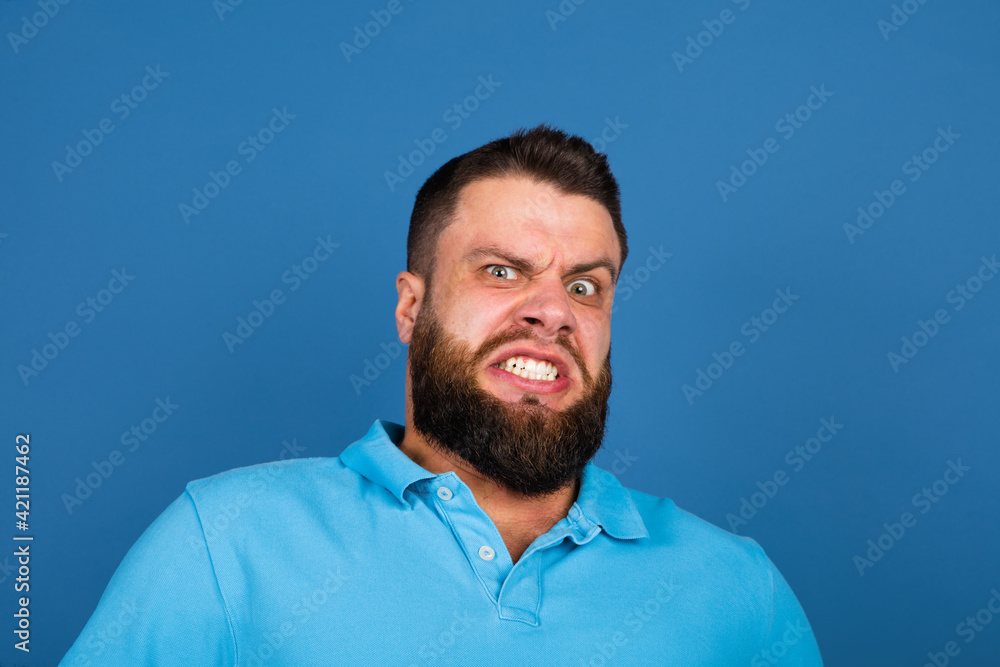 Fototapeta premium Caucasian man's portrait isolated on blue studio background with copyspace