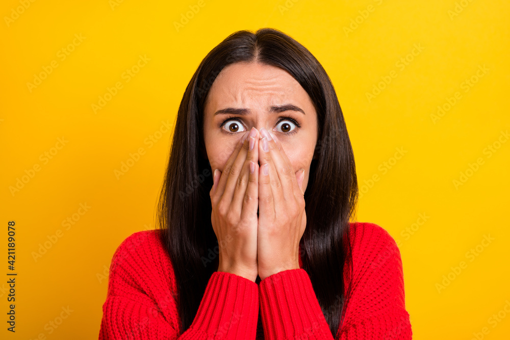 Photo of young shocked amazed surprised scared frightened woman cover mouth in fear isolated on yellow color background Photo of young shocked amazed surprised scared frightened woman cover mouth in fear isolated on yellow color background